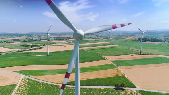 Aerial Flight Near Wind Turbines Energy Production. Clear Renewable Energy Concept alt