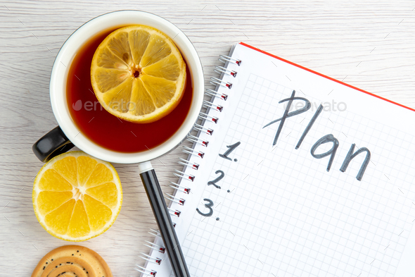 top view open notepad with cup of tea and plan written list on light white background school