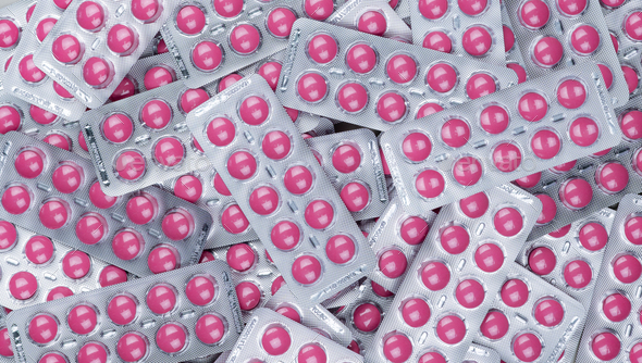 Full frame heap of round pink tablets pills in blister pack. Prescription drugs. Painkiller medicine