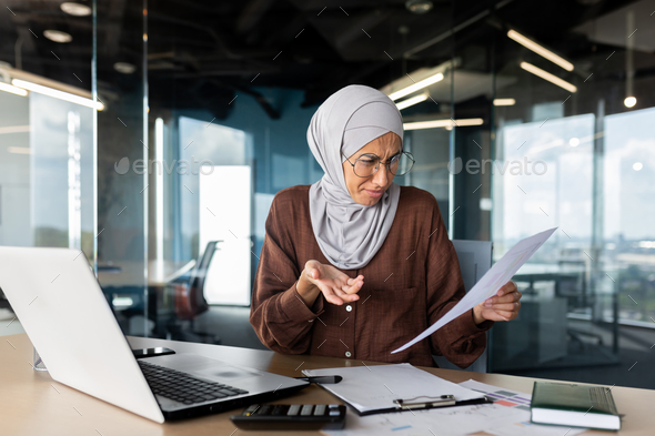 Financial problems, broken contracts, agreements. Confused young Muslim hijabi businesswoman