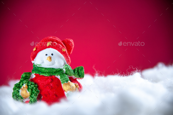 front view mini snowman on red background with free space xmas