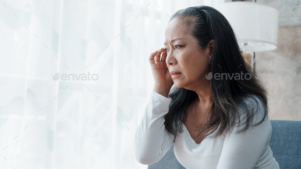 Mature woman feeling sad, asian elderly housewife anxiety depressed thinking serious.