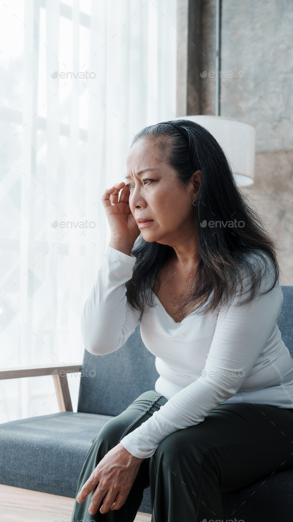 Mature woman feeling sad, asian elderly housewife anxiety depressed thinking serious.