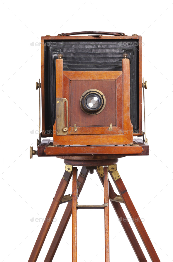 Antique bellows style camera front view close up on an old tripod isolated on white - Stock Photo - Images