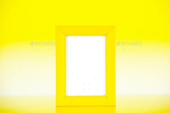front view yellow picture frame on a yellow background color gift present portrait family photo