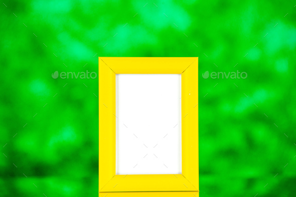 front view yellow picture frame on green background color shoot picture gift portrait family photo