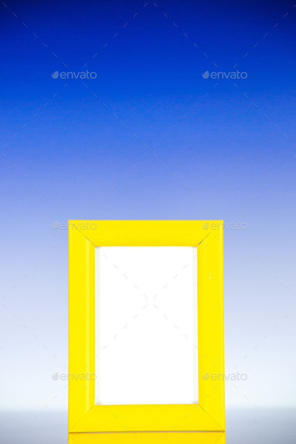 front view yellow picture frame on light blue background family color gift present photo shoot