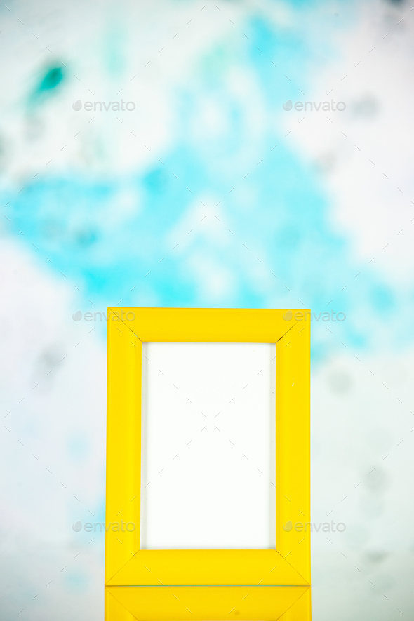 front view yellow picture frame on light blue background portrait photo color shoot present gift