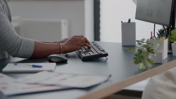 Closeup of Teenager with Dark Skin Hands on Keyboard Typing Email on Computer alt