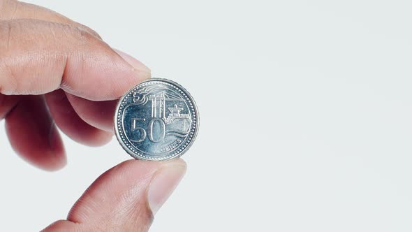 Fingers Hold A Singapore 50cent Coin Back