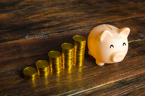 Increasing stacks of coins and a piggy bank.  - Stock Photo - Images