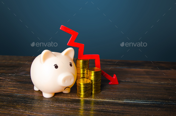 Piggy bank and money with an arrow down.  - Stock Photo - Images