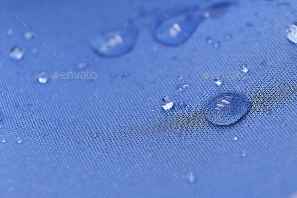 water beading on fabric. Waterproof coating background with water drops