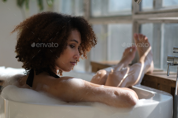 young woman relaxing and takes bubble bath in bathtub with foam, People  Stock Footage ft. woman & bath - Envato Elements