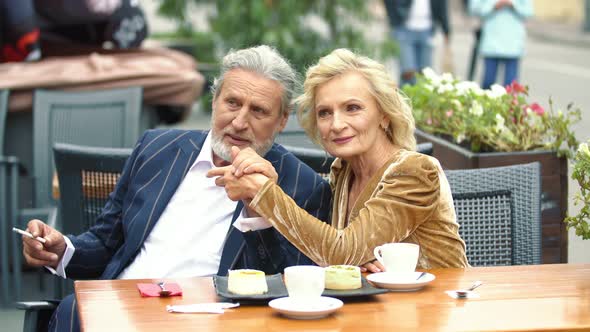 Elderly Couple Sitting at the Table alt