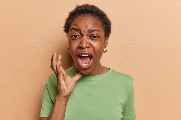 Young Dark Skinned Woman Screams Frustrated And Furious Keeps Mouth