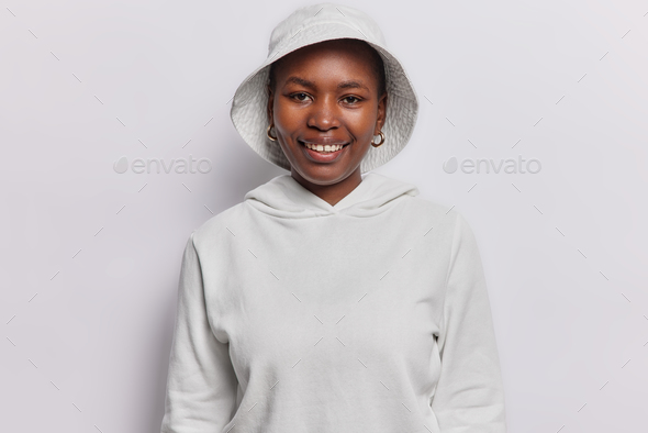 Portrait of cheerful Afro American teenage girl smiles gladfully happy to meet friend wears casual