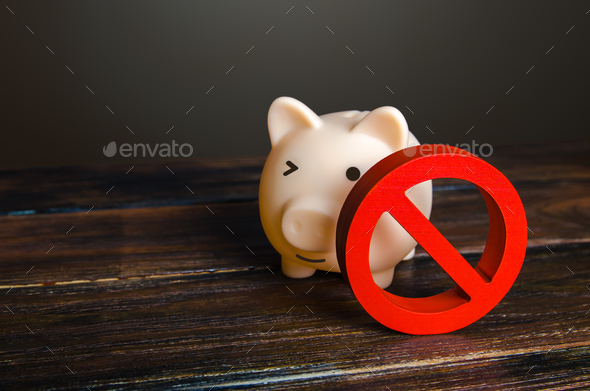 Piggy bank and prohibition sign NO. Bypass restrictions, loopholes in laws.  - Stock Photo - Images