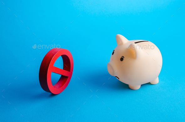 Piggy bank staring at a red prohibition sign no. Blockages and restrictions in working with finances - Stock Photo - Images