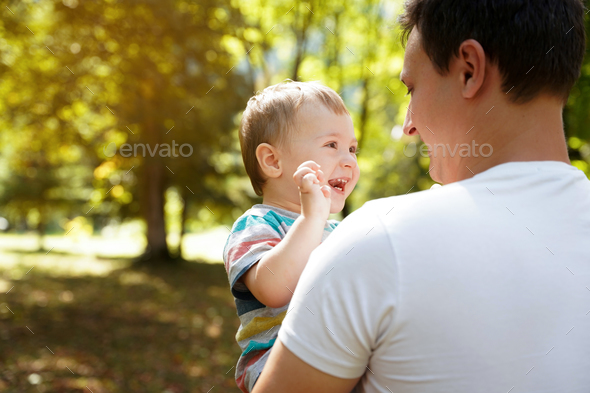 Dad plays with his little son in the park outdoors. Family time. Happy smiling people. - Stock Photo - Images