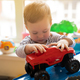 Toddler boy plays with car toys in the children&#39;s room. E - PhotoDune Item for Sale