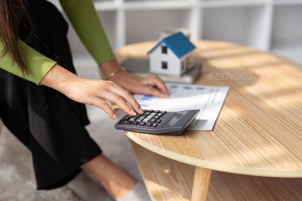 Woman renter using calculator for business financial accounting calculate money bank house loan