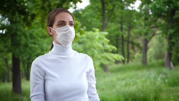 Young Woman Takes Off Medical Mask. Female Breathes Deeply and Smiling