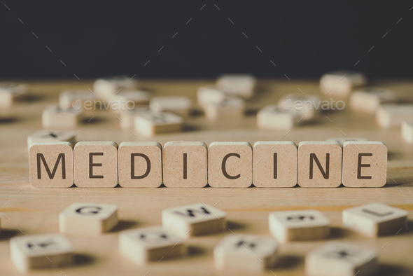 selective focus of medicine lettering on cubes surrounded by blocks with letters on wooden surface