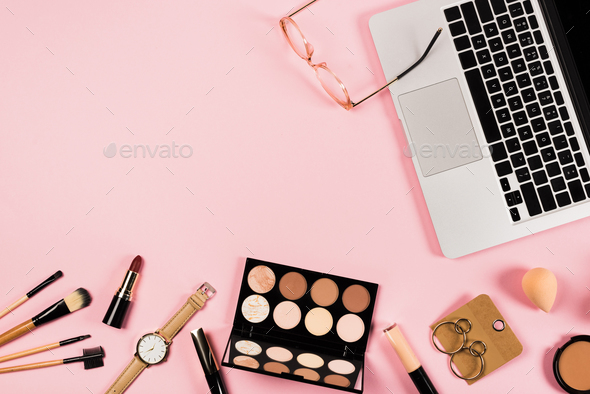 top view of laptop, accessories and decorative cosmetics on pink - Stock Photo - Images