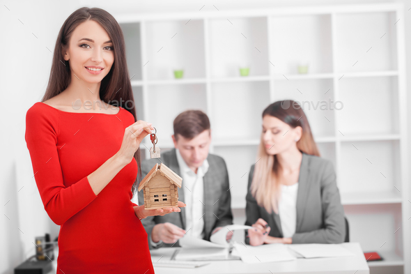 Young smiling couple about to sign a house renting agreement