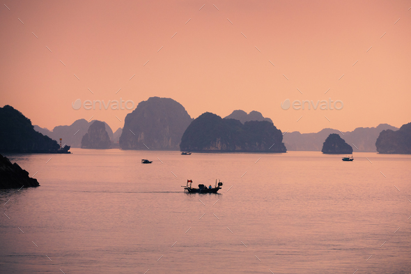 Small boats in the middle of karst formations in sea