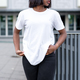 Sleek and chic: A young black woman poses in a fashionable white t