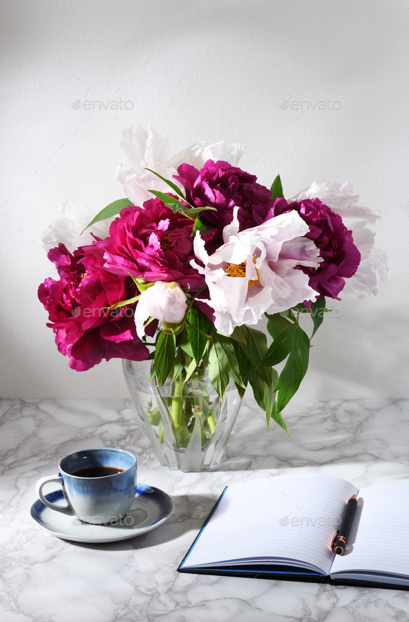 Bouquet of beautiful peonies with cup of coffee - Stock Photo - Images