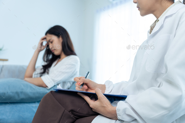 Asian psychology doctor examine and listen to woman patient at home.