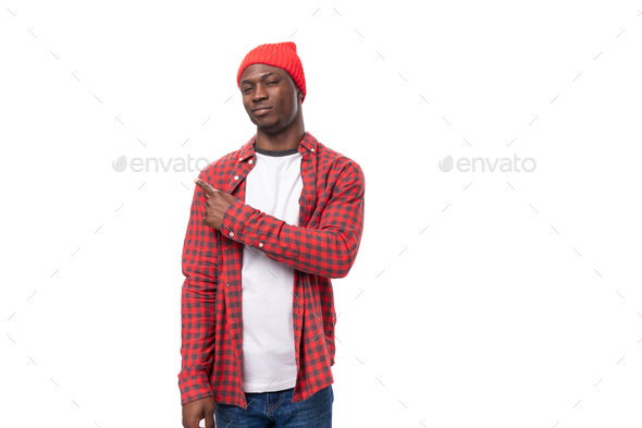 confident young american man in red headdress and shirt pointing with hand at promotional offer on