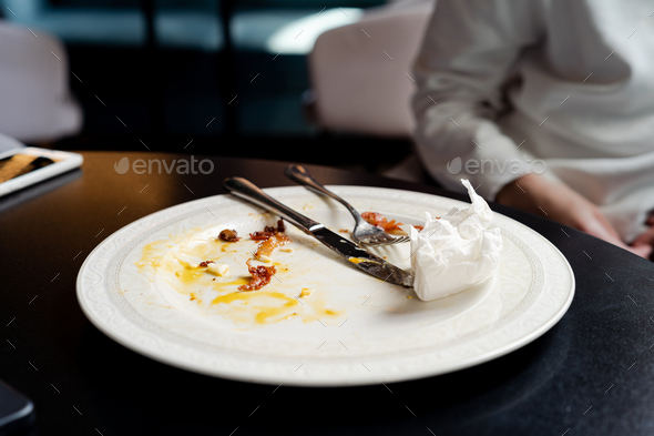 Dirty plate after eating on the table close-up - Stock Photo - Images