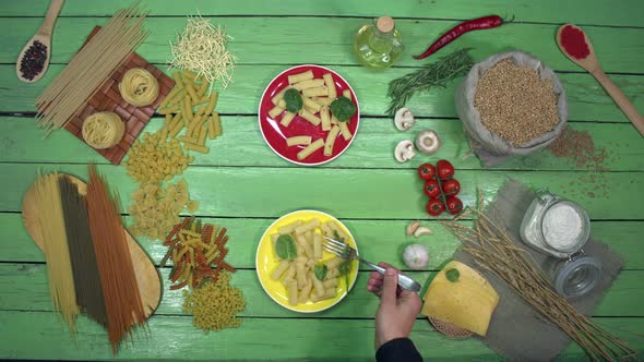 Tasting Pasta on colourful Plates with Spinach.