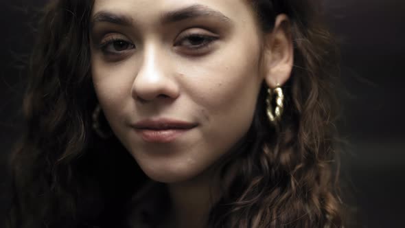 Closeup of a Smiling Girl in Front of an Opening Elevator alt