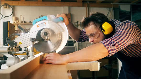 Woodworker with a Circular Saw Is Processing Wood in Slow Motion alt
