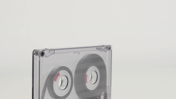 Compact  audio cassette on white background 4K 2160p 30fps UltraHD tilting footage - Transparent ana alt