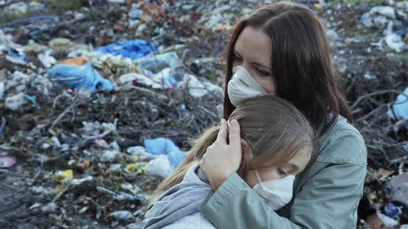 Woman Hugs Her Daughter. Ecological Problem