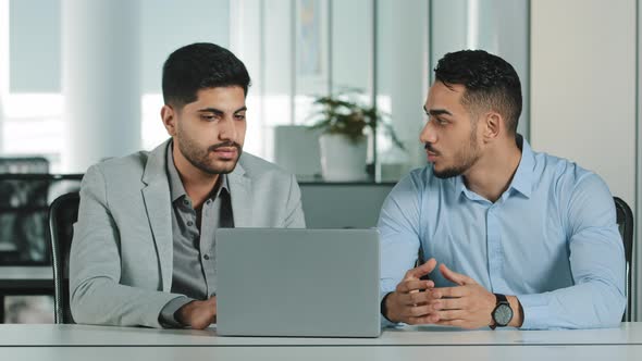 Two Male Colleagues Employees Cooperating in Office Talking Working Together at Workplace Serious alt