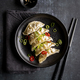 A plate with fresh gyoza dumpling on black plate and background with chopsticks - PhotoDune Item for Sale