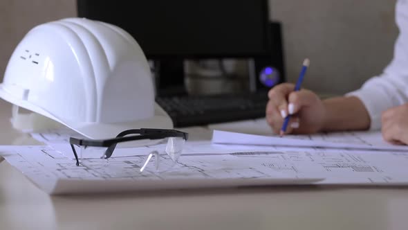 Construction engineer makes notes on the drawings alt