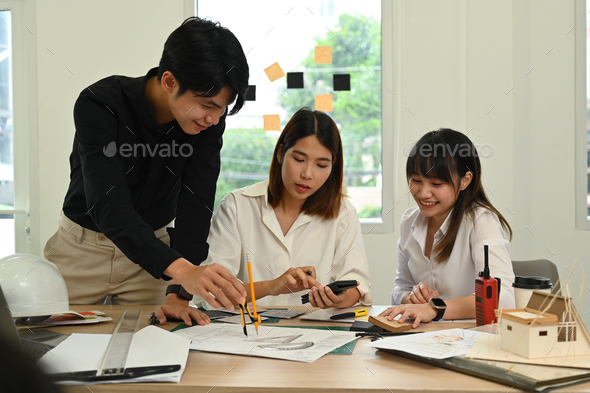 Group of creative people working on scale model house, preparing ...