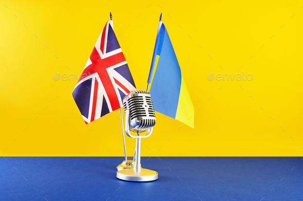Microphone on a background of a blurry flags Ukraine and Great Britain. European Song Contest