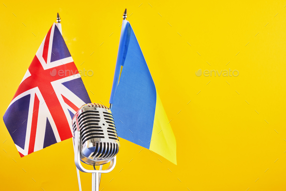 Microphone on a background of a blurry flags Ukraine and Great Britain. European Song Contest