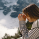 Woman closed her eyes, praying near the mountain. - PhotoDune Item for Sale