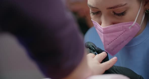 Manicurist Applies Gel Lacquer to the Nails of the Client at Beaty Salon Cosmetology and Beauty alt