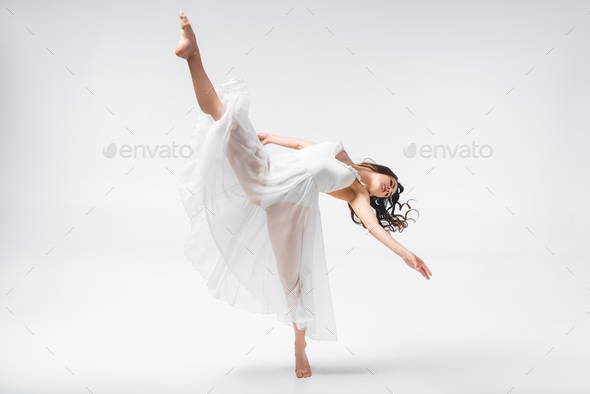 beautiful ballerina in white dress dancing on grey background Stock Photo  by LightFieldStudios